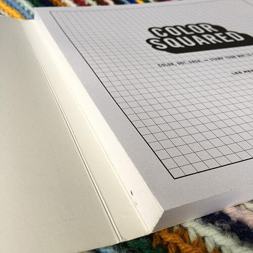 spine of Color Squared book, which is made so that pages can easily lie flat and be removed