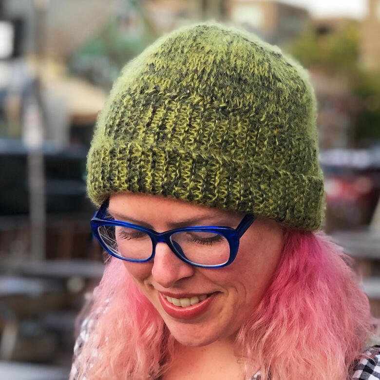 Lee wearing green hat with halo and folded up brim